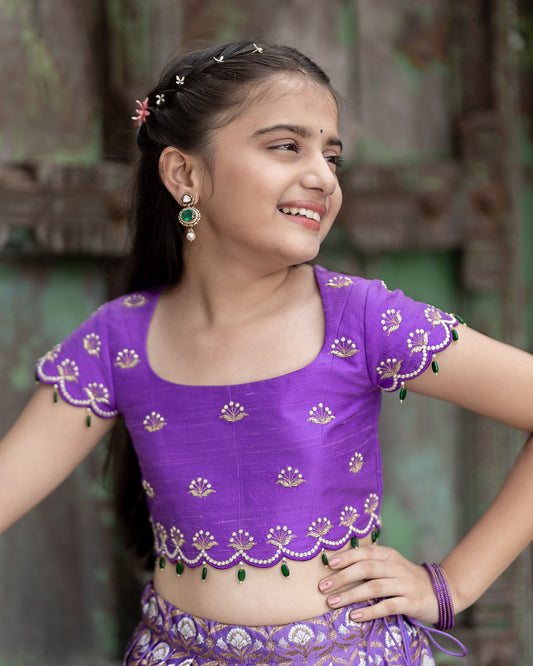 A DARK LAVENDER BANARASI LEHENGA WITH LAVENDER BLOUSE.