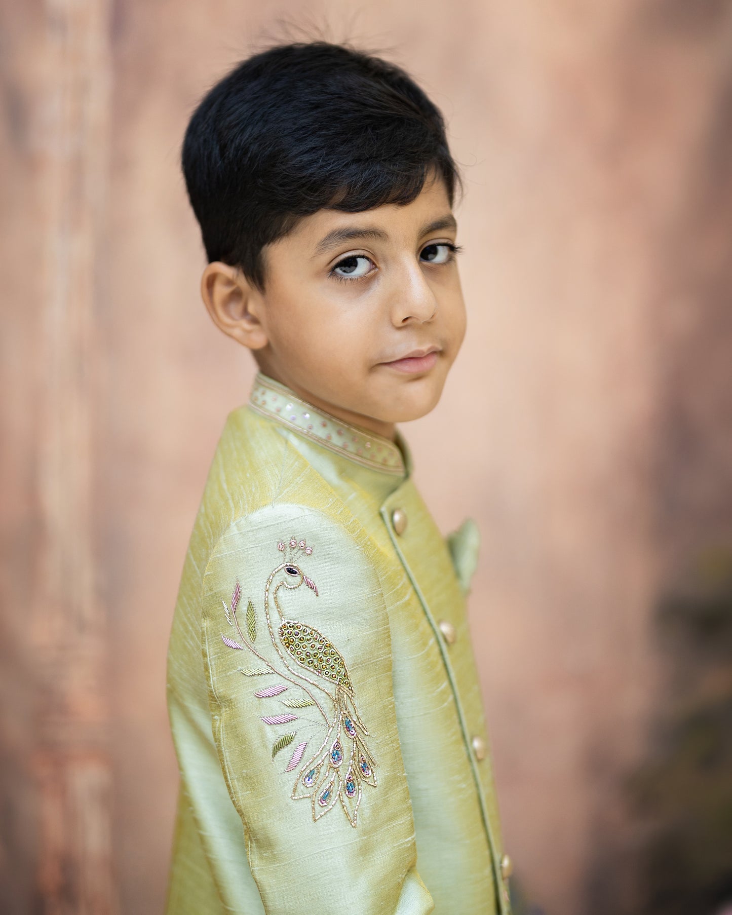 A SAGE GREEN SHERWANI WITH PEACOCK EMBROIDERY